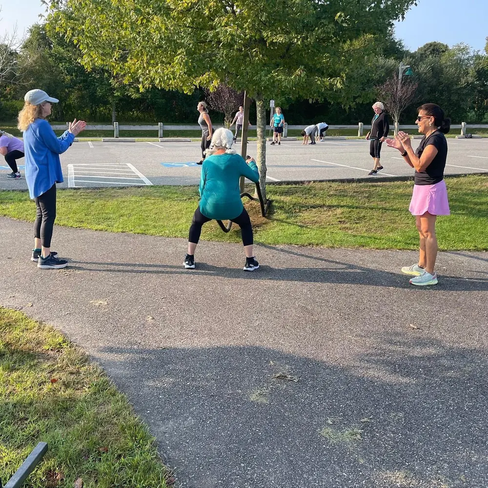 SC Boot Camp members of all ages working out with dumbbells outdoors